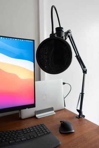 Computer and professional microphone setup on desk